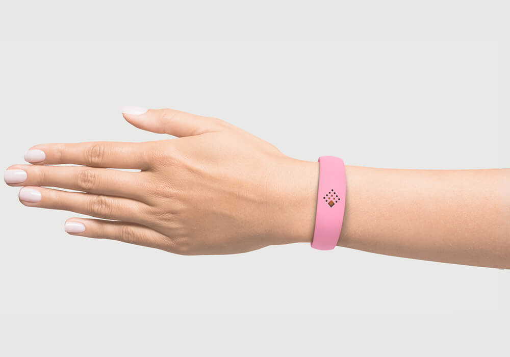 Pink AMBRIO bracelet on the hand of a woman mob